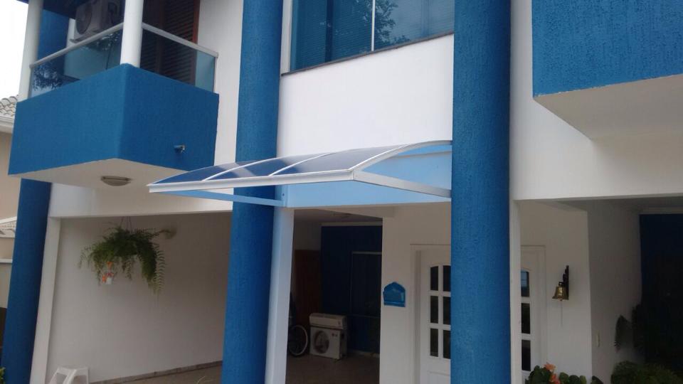 Toldo fixo em policarbonato sobre área de serviço